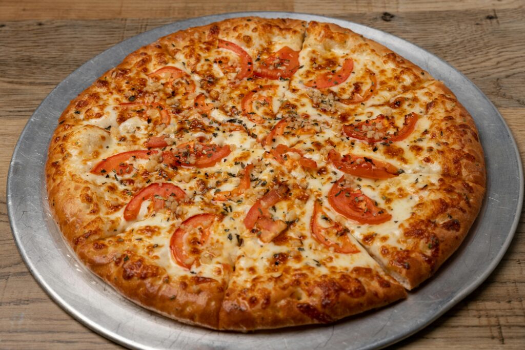 pexels photo 29872749 29872749 Savor a freshly baked Margherita pizza topped with ripe tomatoes and melted mozzarella cheese.
